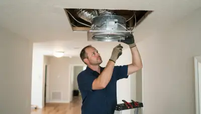 San Antonio electrician installs a ceiling-mounted whole-house fan with insulated damper