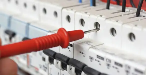 Electrical contractor testing circuit breakers during electrical repair in Helotes, TX
