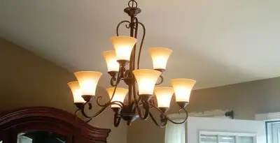Classic ceiling chandelier installation with warm lighting in San Antonio, TX