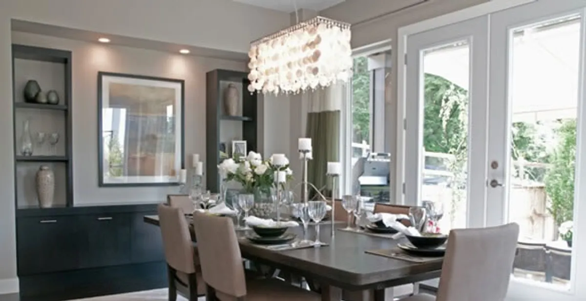 Elegant dining room chandelier installation above table in San Antonio, TX