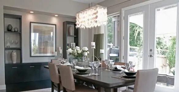 Elegant dining room chandelier installation above table in San Antonio, TX