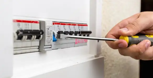 electrical panel upgrade service showing technician adjusting circuit breakers during system upgrade in San Antonio, TX