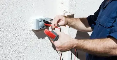 Electrician performing home electrical outlet and wiring inspection in San Antonio, TX