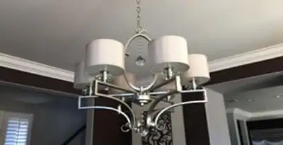 Modern chandelier installation with multiple light fixtures in San Antonio, TX