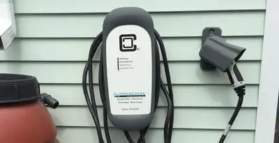 Outdoor electric vehicle charger installation on residential wall in San Antonio, TX