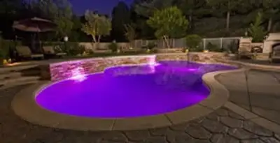 pool light installation and repair services illuminating a residential swimming pool in San Antonio, TX
