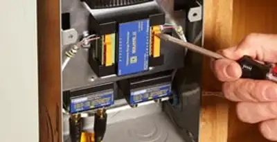 Whole home surge protection device being installed by a licensed electrician to protect electrical systems in San Antonio, TX